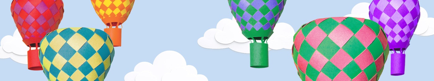 Colorful hot air balloons floating in a blue sky with clouds.
